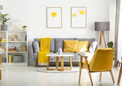 Yellow wooden armchair and table in living room interior with po